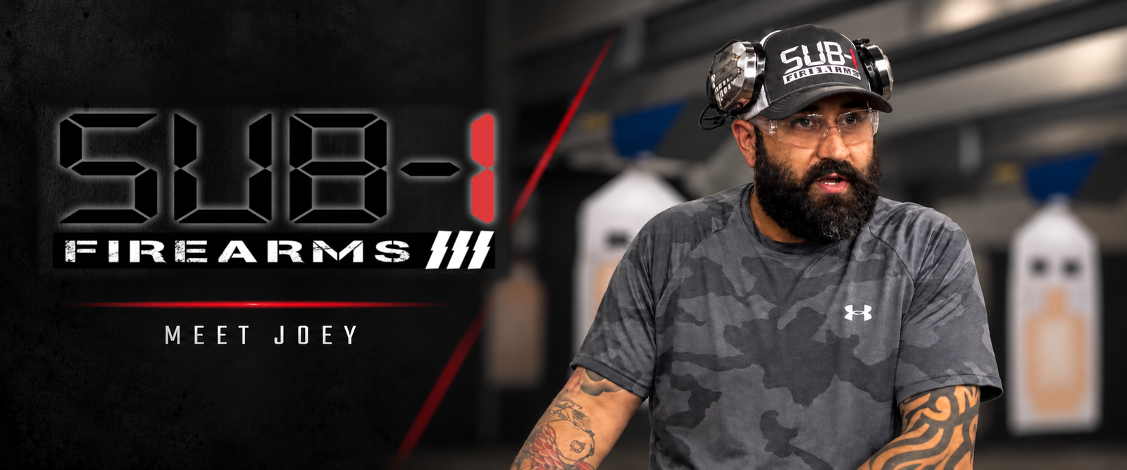 Studio portrait of Joey beside the original Sub-1 Firearms logo
